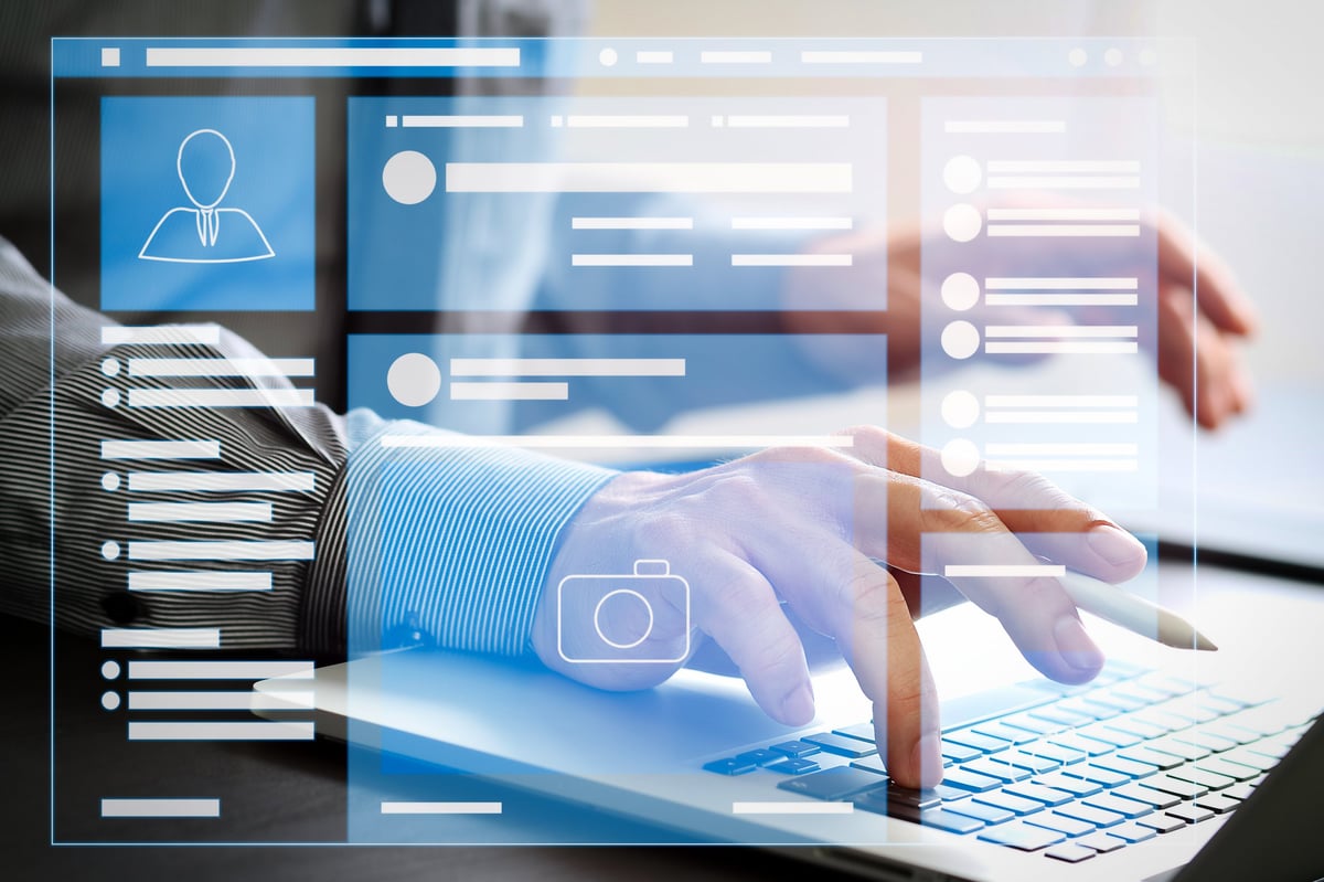 Professional person working on laptop with LinkedIn profile visible